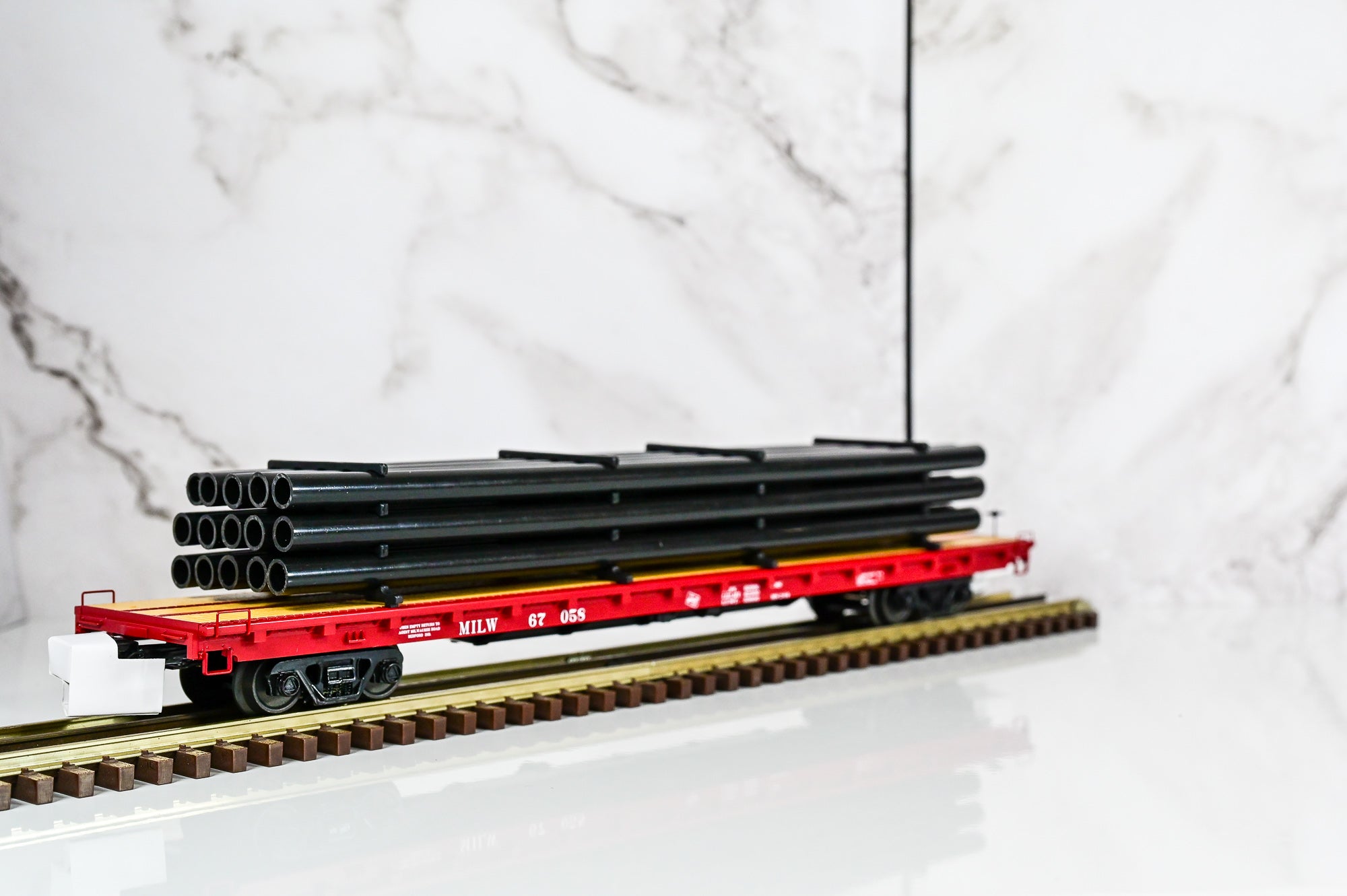 MTH Milwaukee Road 60' Flat Car w/Pipe Load #67058 | O Scale